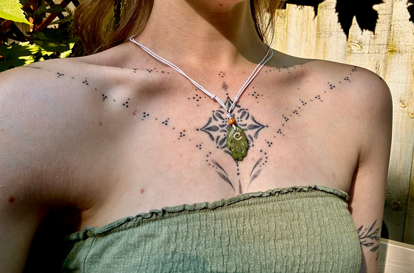 Green healing hand pendant necklace.