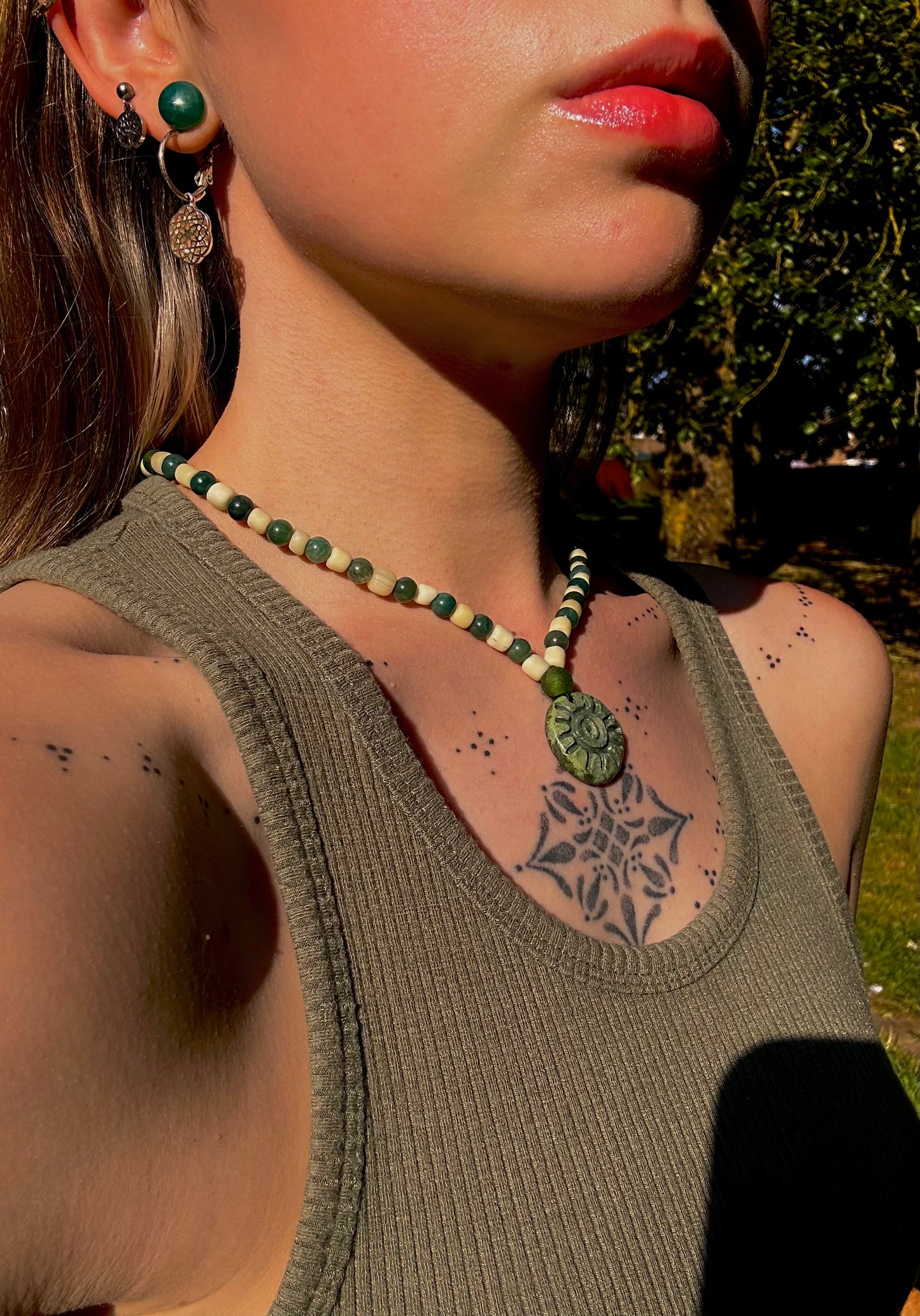 Fully beaded pendant necklace.