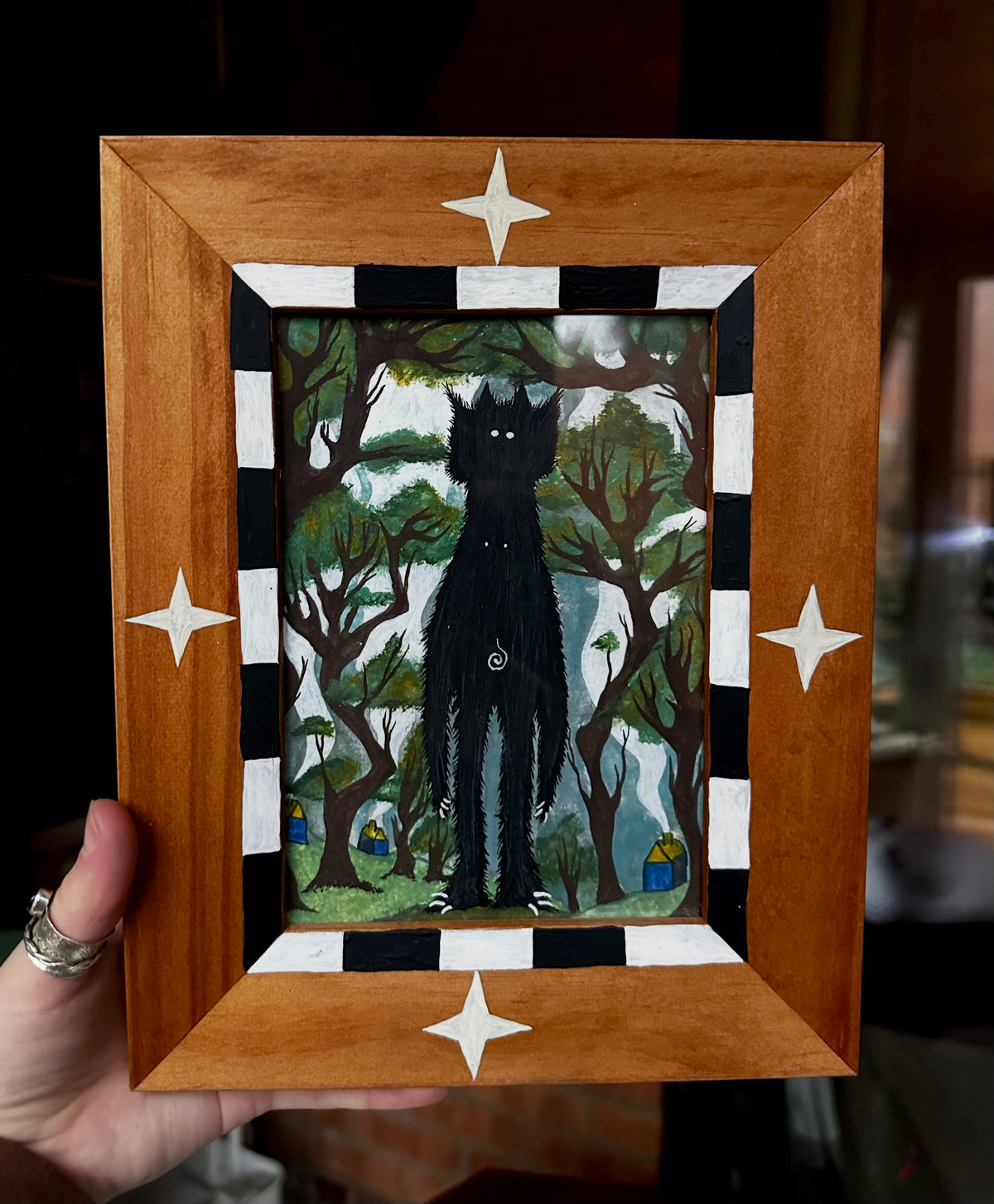 Hand-painted ‘unknown creature’ in hand-painted frame.