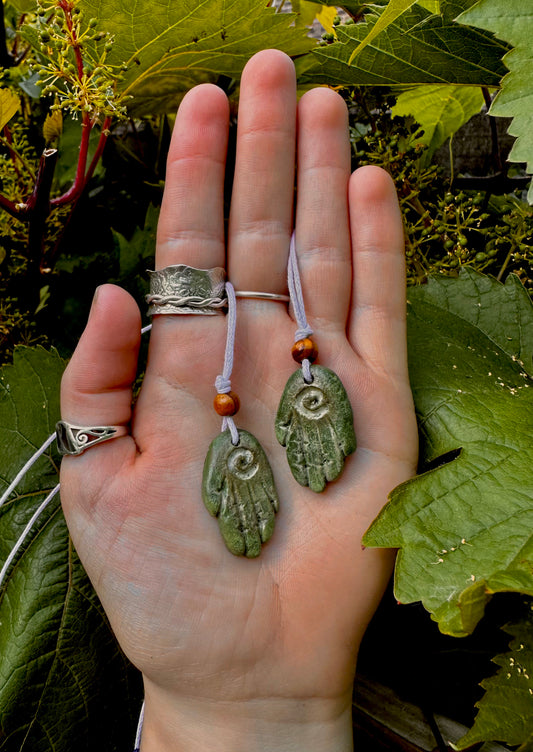 Green healing hand pendant necklace.