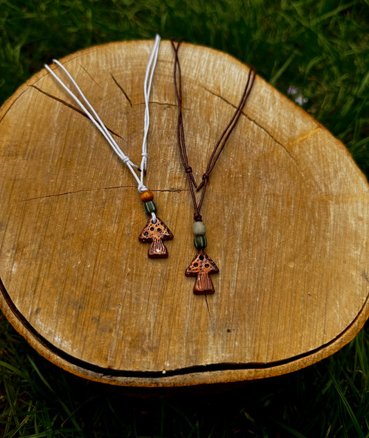 Copper mushroom pendant necklace.