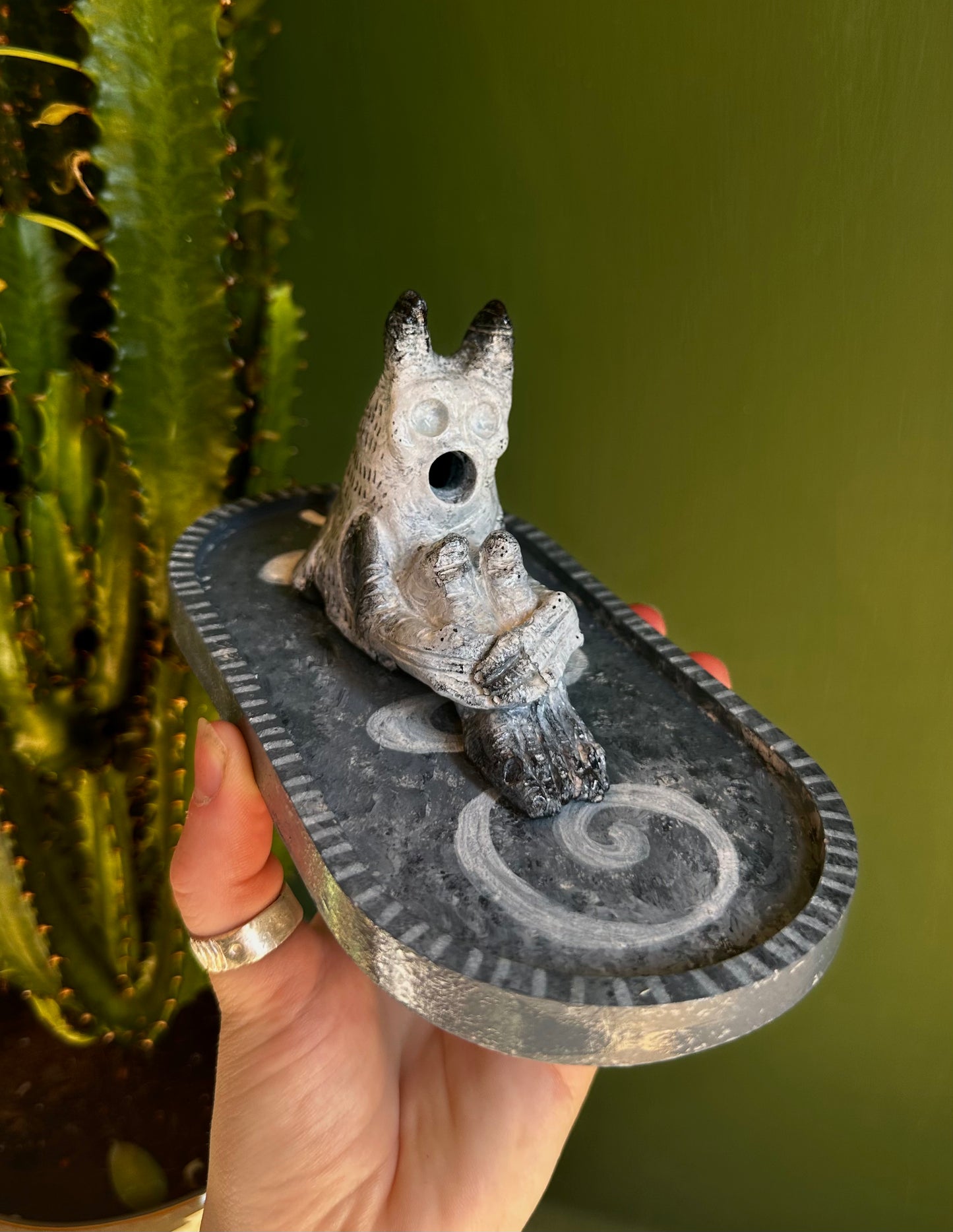 The pondering exhales, incense creature.